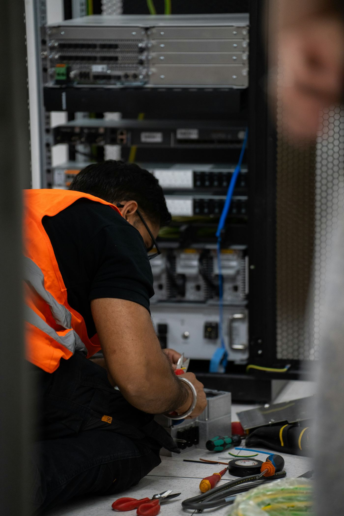 Field engineer servicing network equipment in a rack
