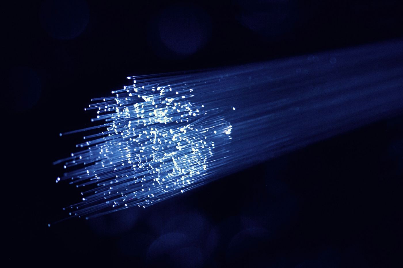 Strands of fibre-optic cable glowing blue